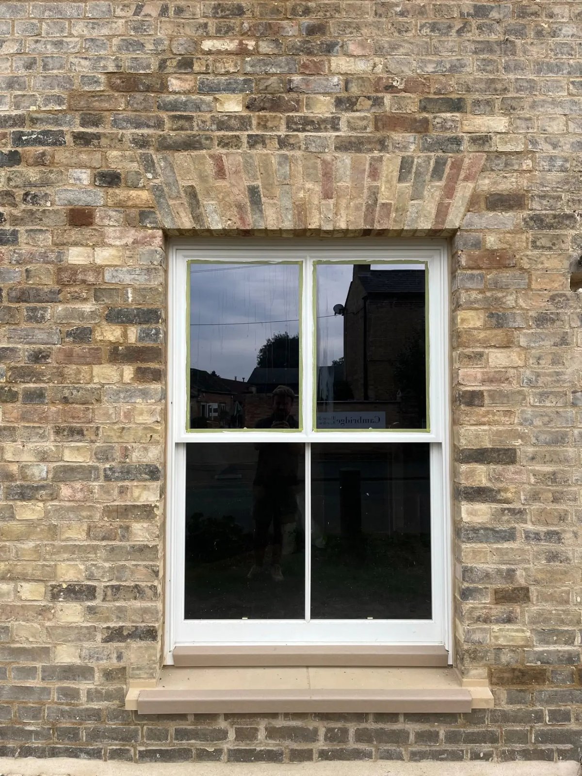 New sash window set into a rebuilt brick arch with stone cill, Willingham