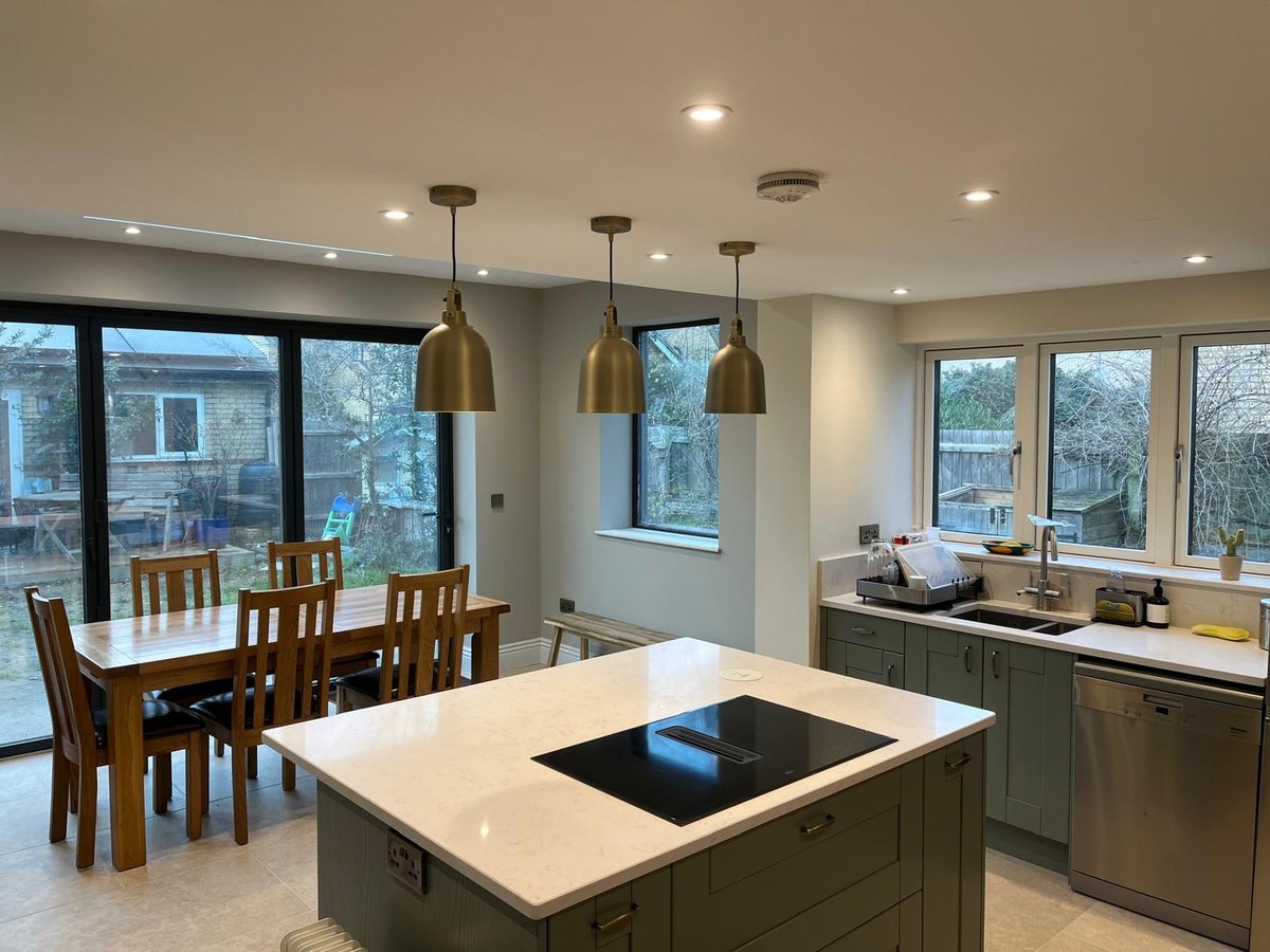 Sage green shaker kitchen with island and bifold doors onto the garden, Prime Build Services kitchen fitting