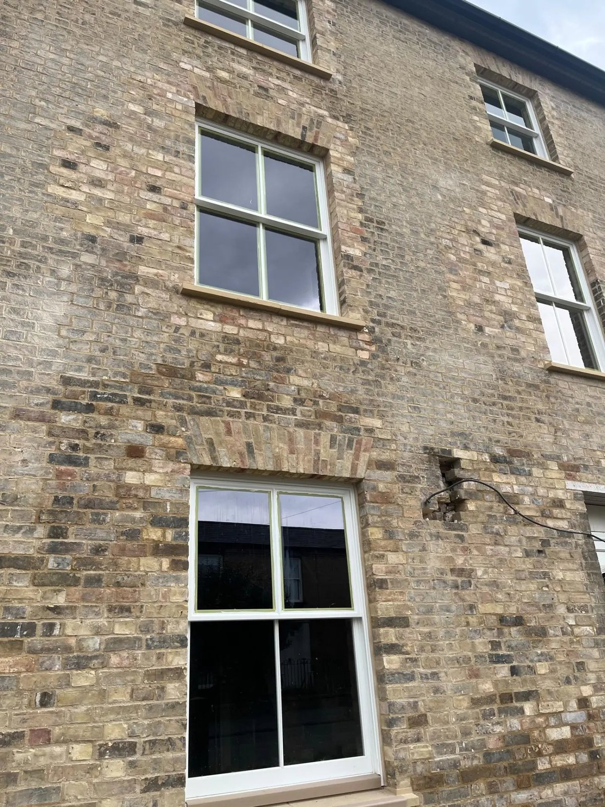 Brick arch rebuilds and masonry repairs around new sash windows, Willingham