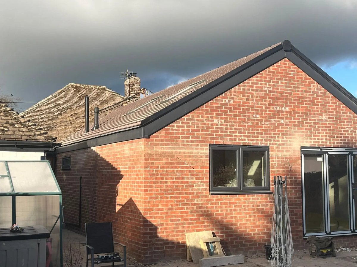 Finished extension side elevation with tiled roof and grey fascias, Wyton