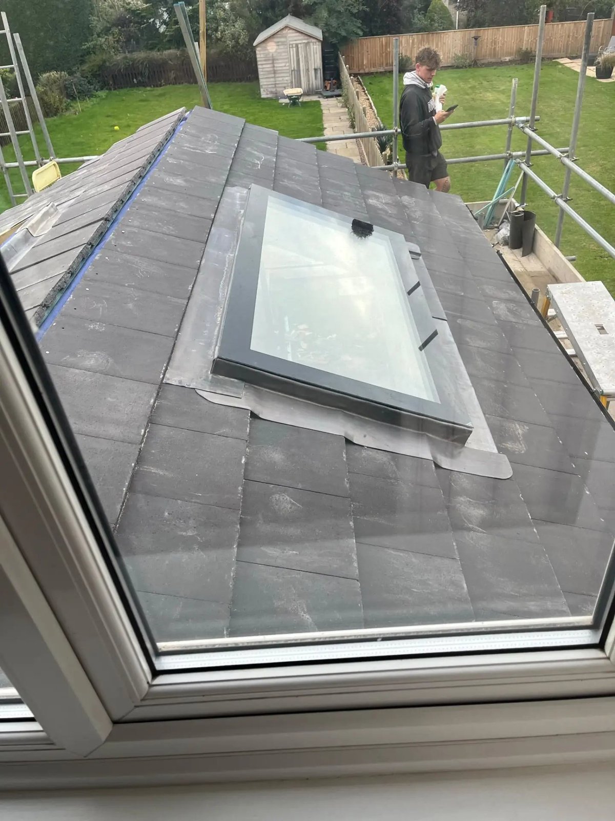 Slate-tiled extension roof with lead flashing around a new rooflight, Warboys