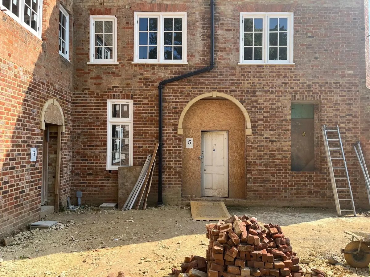 Heritage brick courtyard elevation during careful restoration work