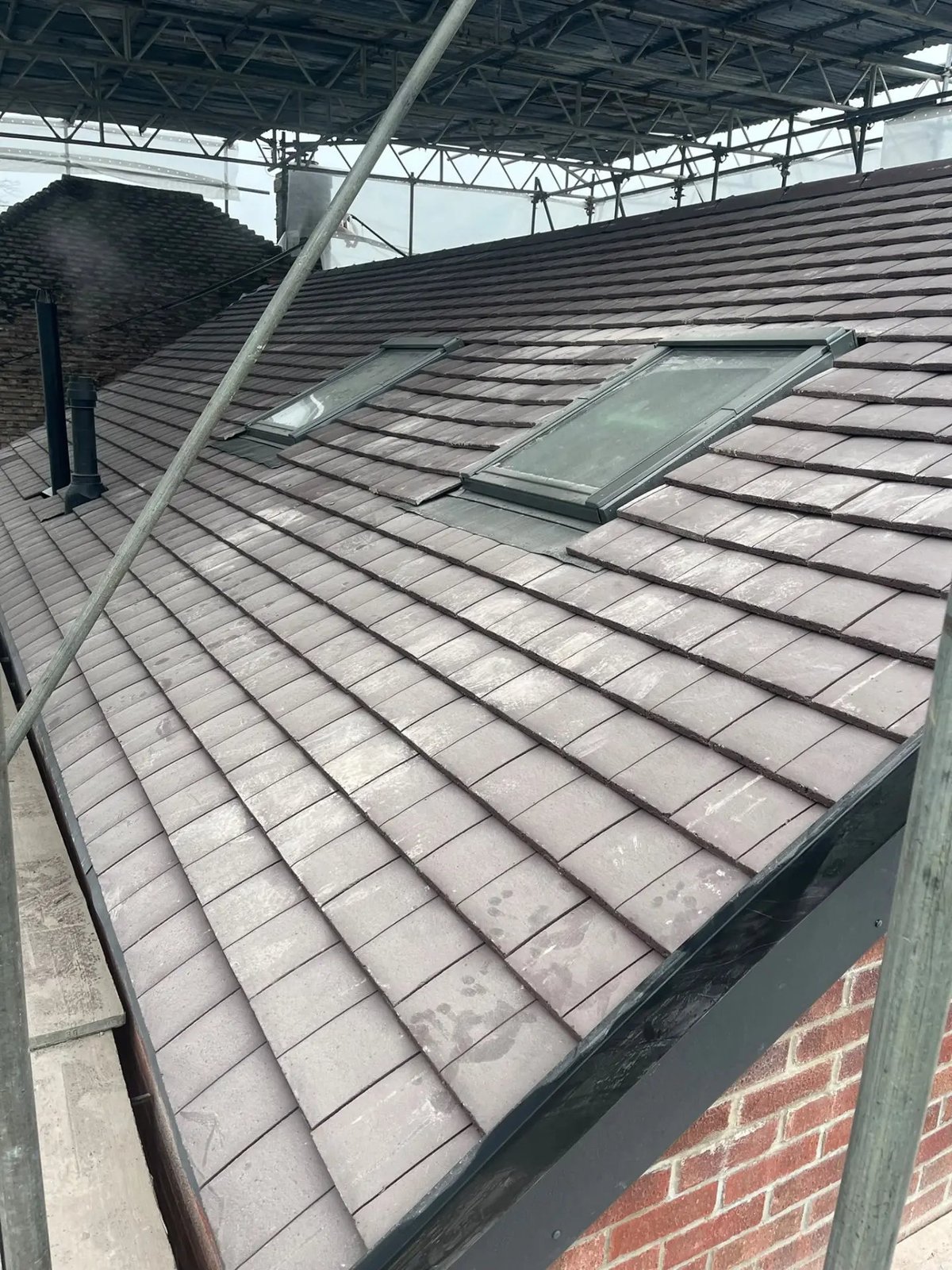 Newly tiled roof with two rooflights and lead flashing, Wyton