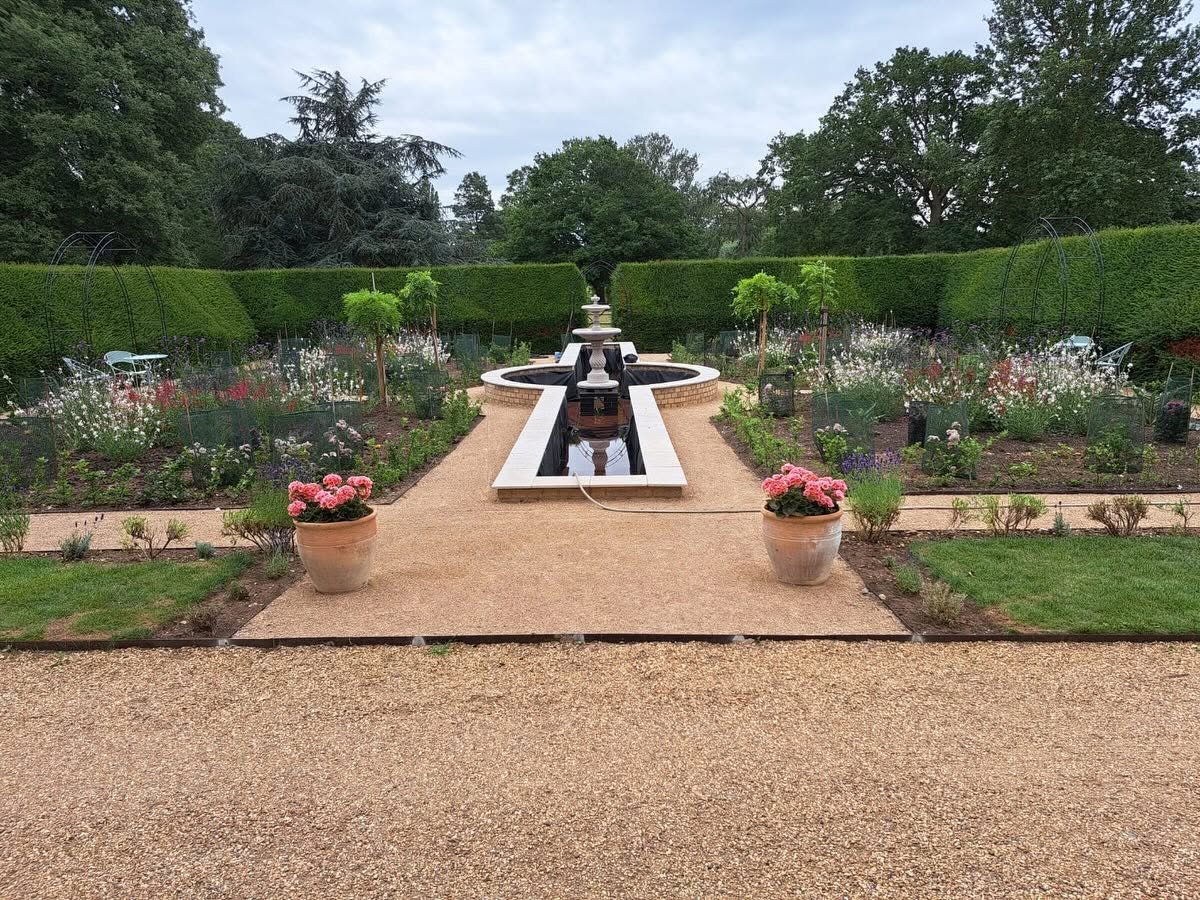 Completed formal garden with brick water feature, fountain, gravel paths and clipped hedging