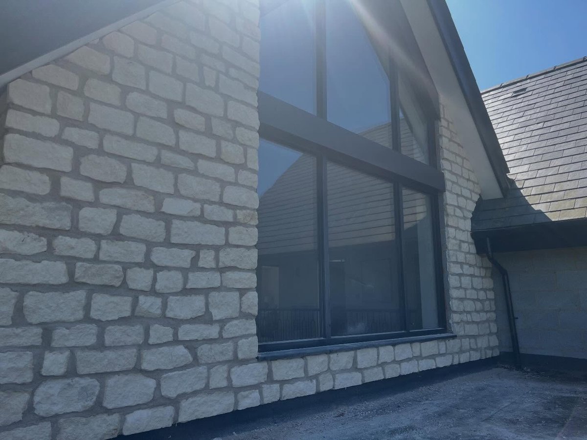 Pale stone cladding detail completed on an external elevation