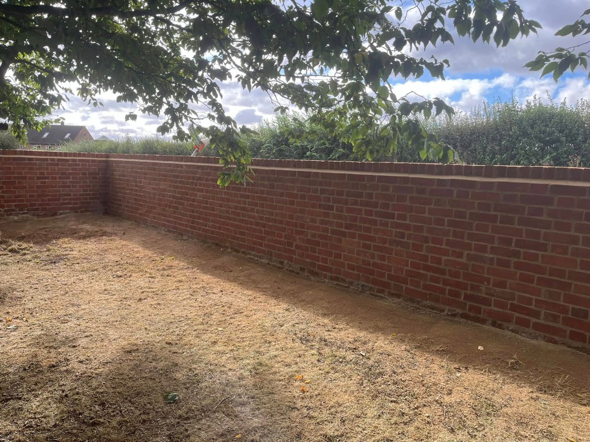 New brick boundary wall enclosing a garden, built by Prime Build Services