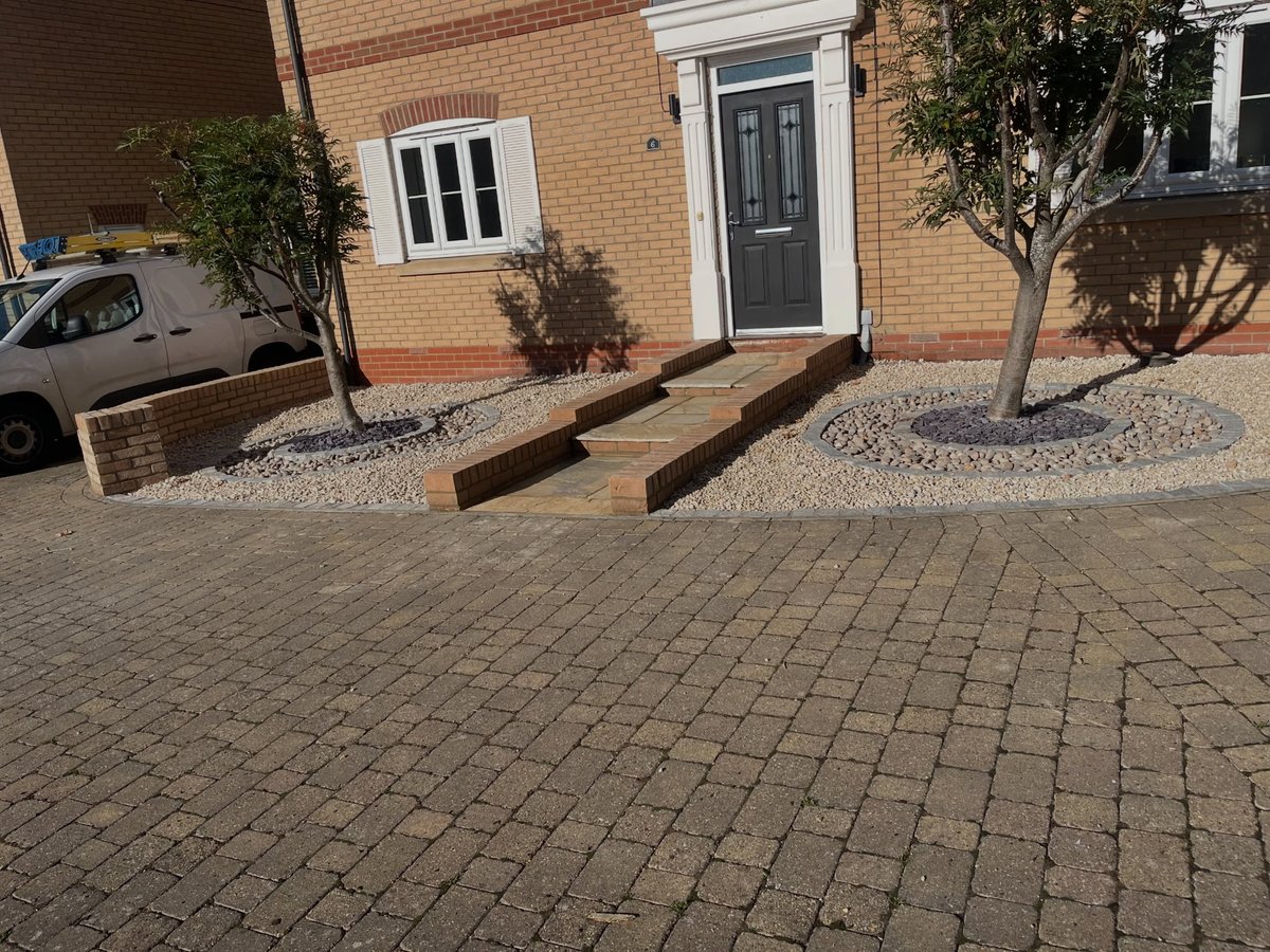 Finished front garden with paved path, trees and gravel borders