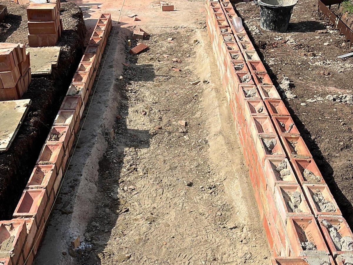 Parallel brick walls built for a formal garden water channel