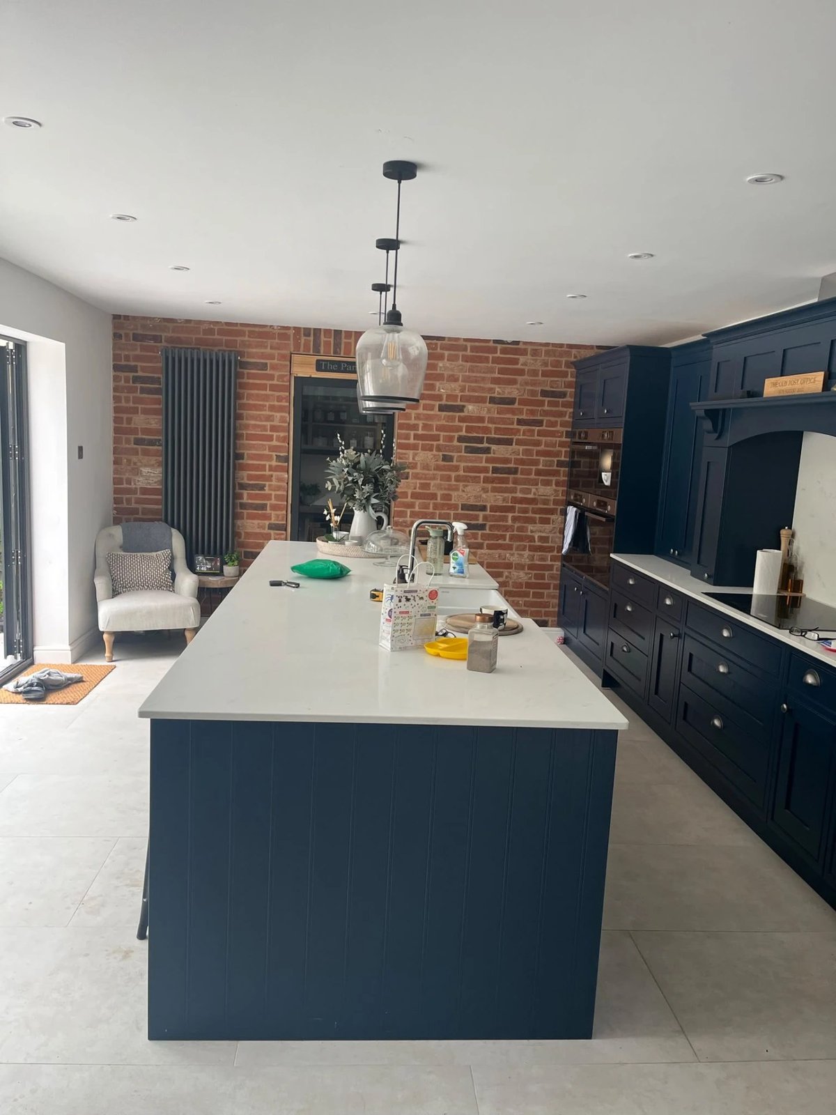 Navy shaker kitchen with quartz island and exposed brick feature wall, High Street Warboys