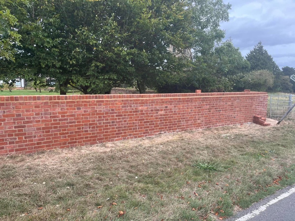 Completed red brick garden wall with neat mortar joints built in Cambridgeshire