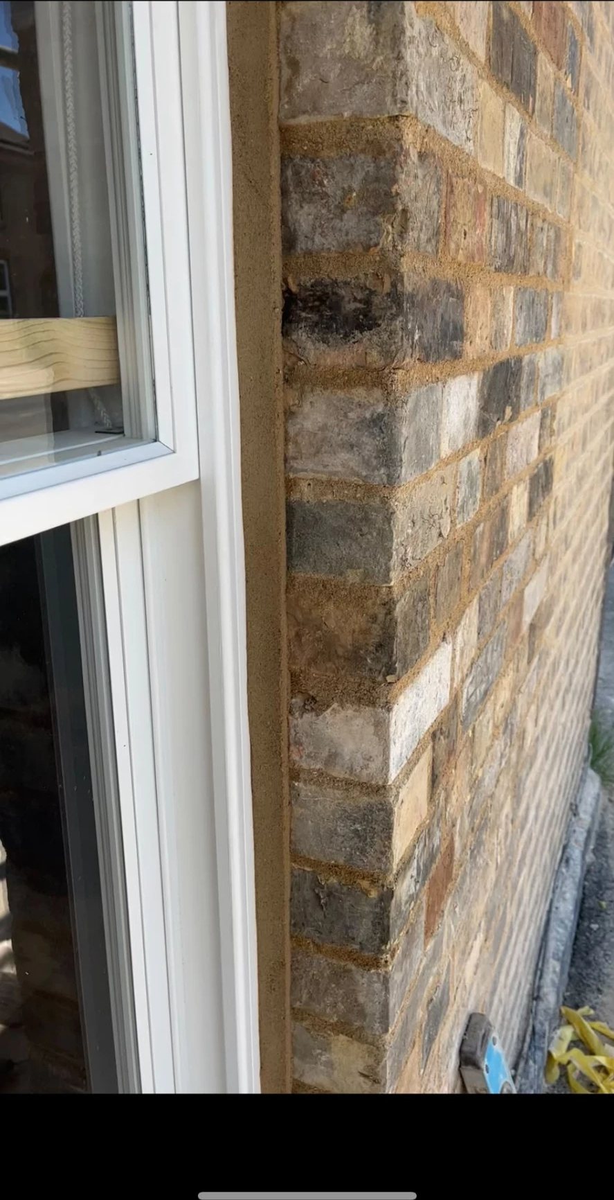 Freshly raked and repointed brick reveal beside a new window frame, Willingham