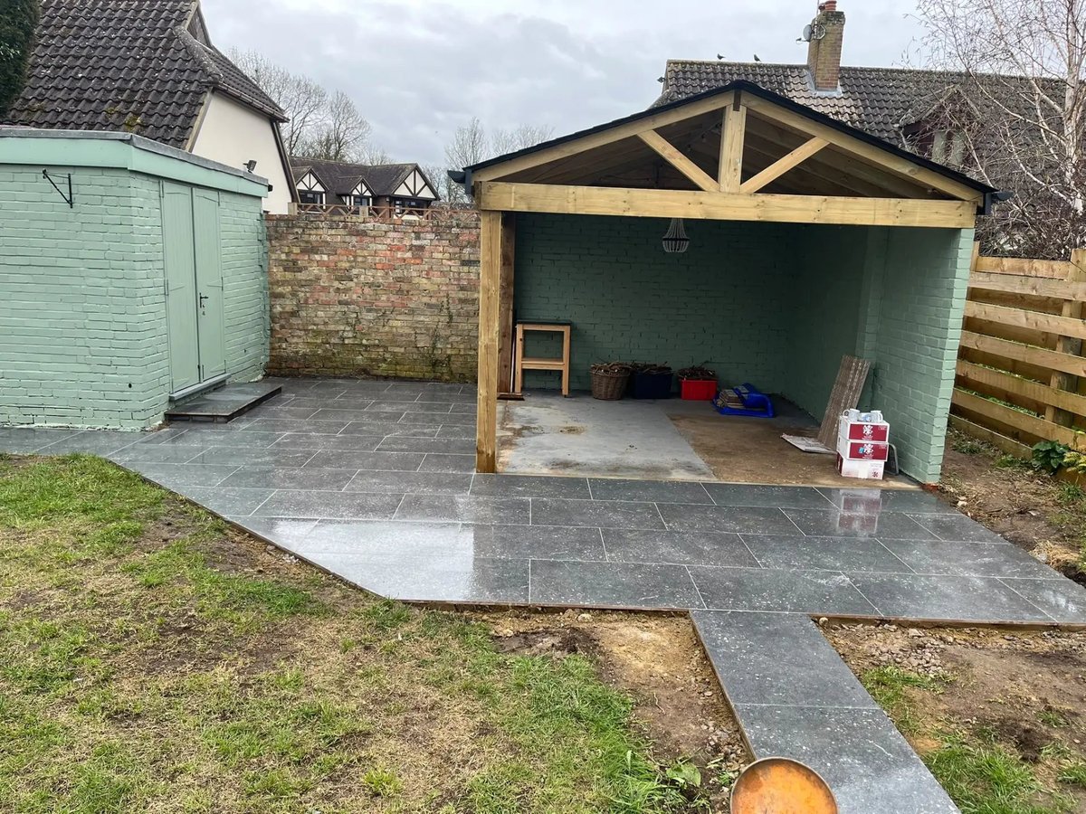 Oak-framed garden shelter with new paving and painted brickwork, Wyton