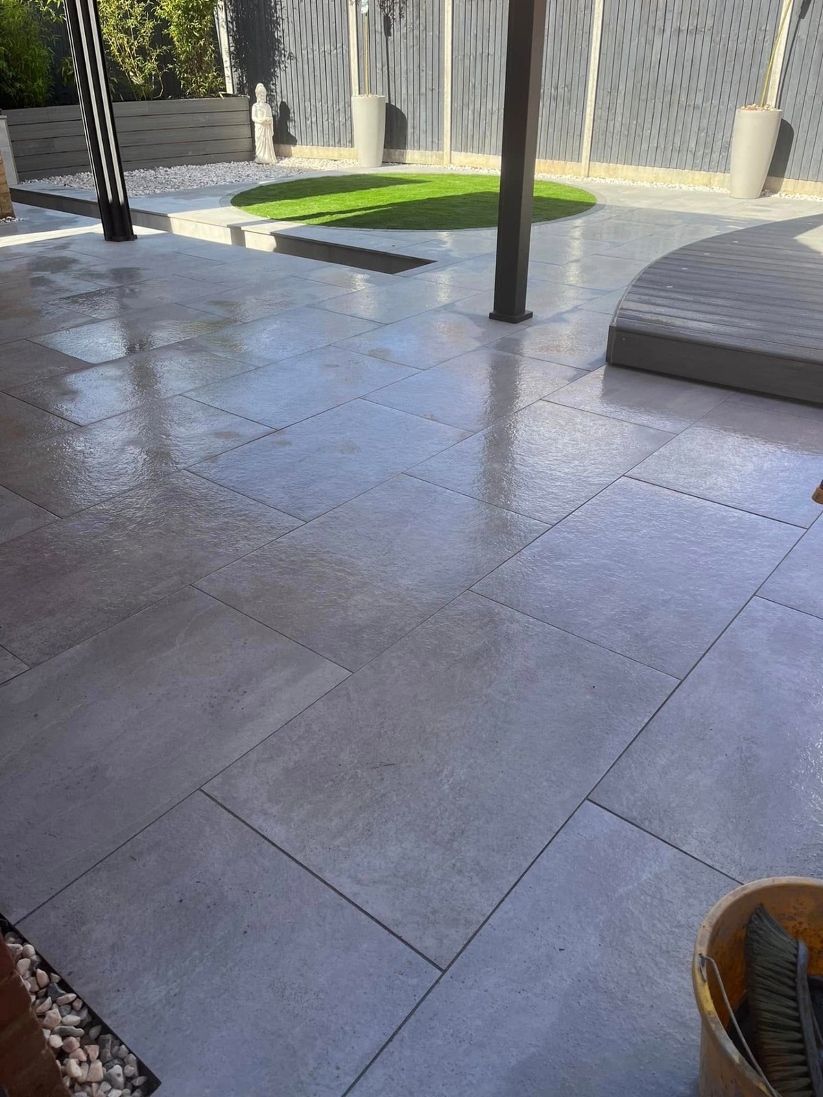 Completed porcelain patio with wide format slabs laid in a Cambridgeshire garden