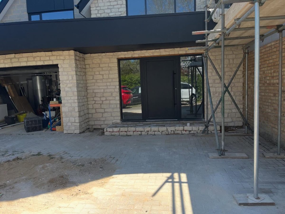 Stone slip cladding finished around a front entrance with clean mortar joints