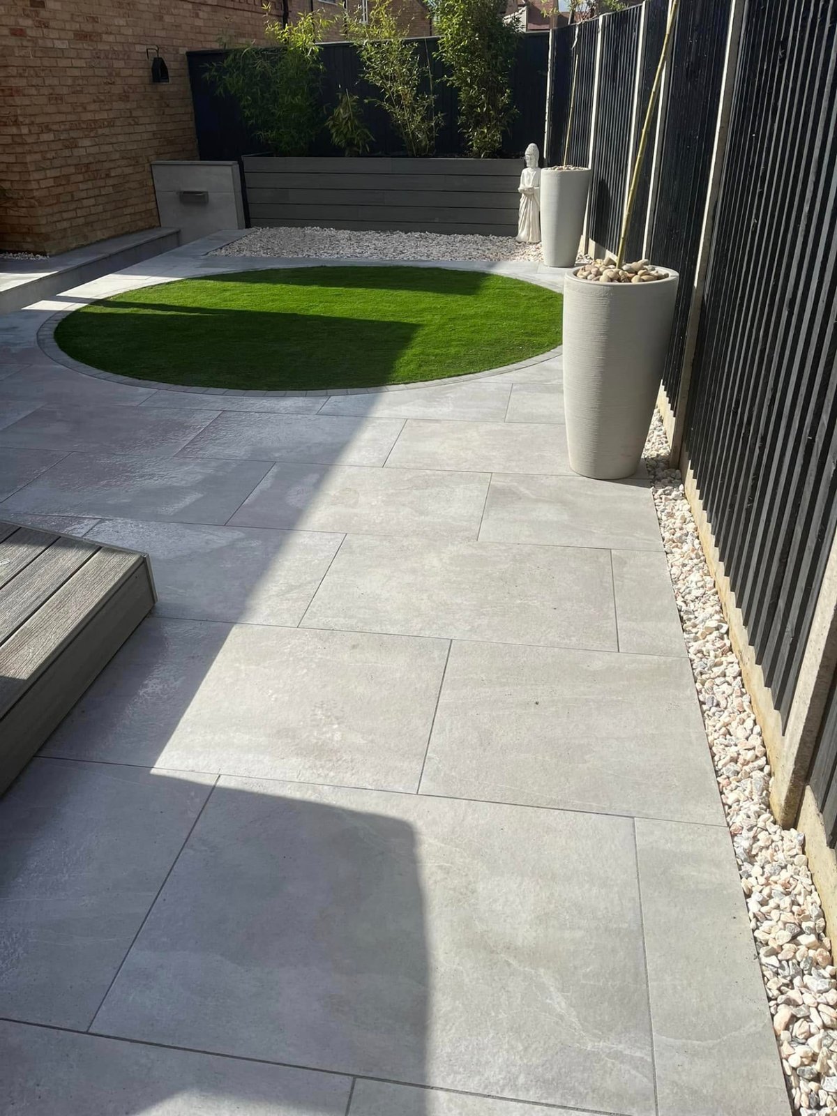 Finished garden landscaping scheme with patio, planting beds and lawn