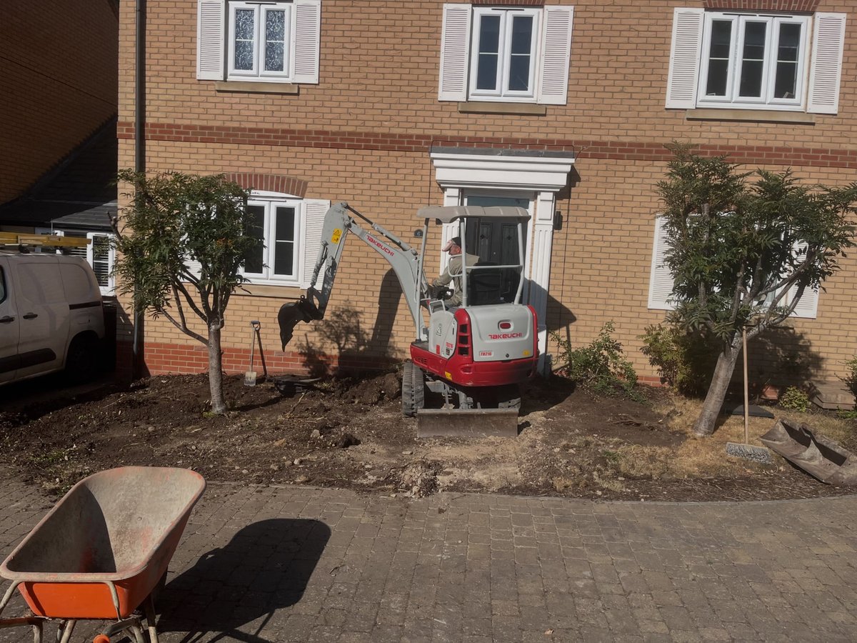 Front garden before renovation with excavator and exposed soil
