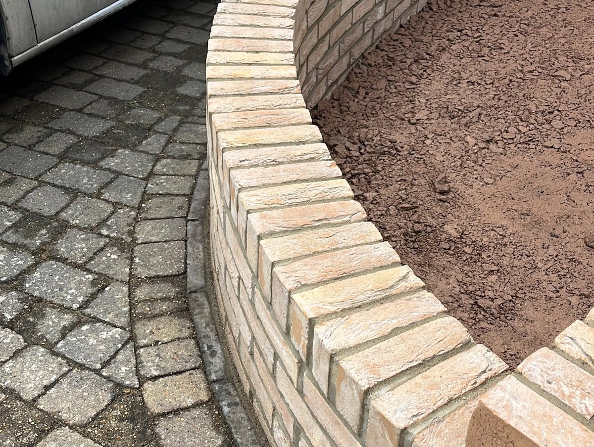 Completed front garden renovation with brick walls, path and gravel beds