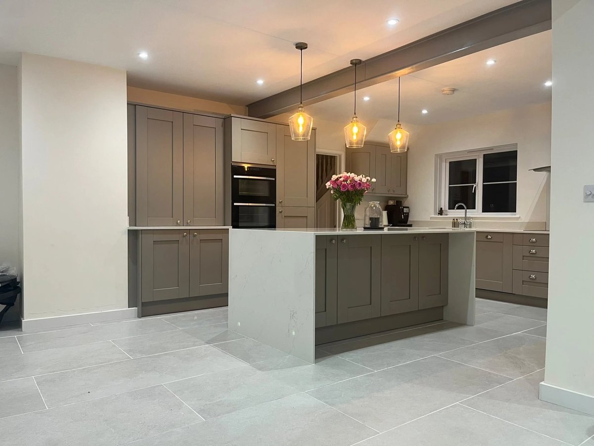 Finished kitchen with tall cabinets, quartz island and large tiled floor, Warboys