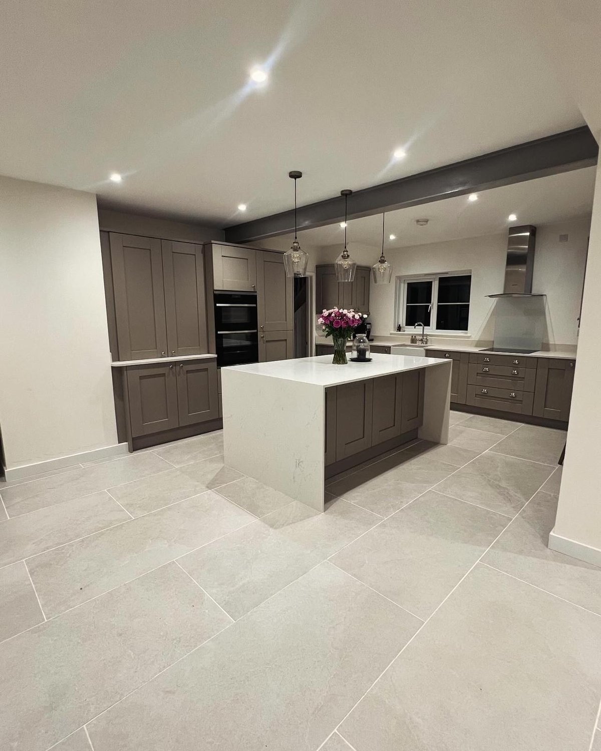Taupe shaker kitchen with marble-effect island and large format floor tiles, Prime Build Services kitchen fitting