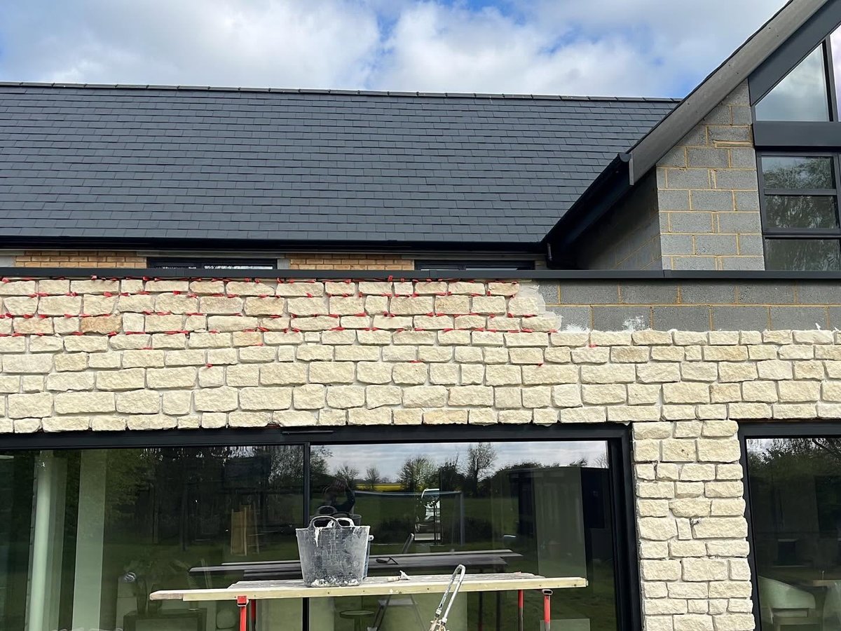Stone slip cladding being installed on an external wall