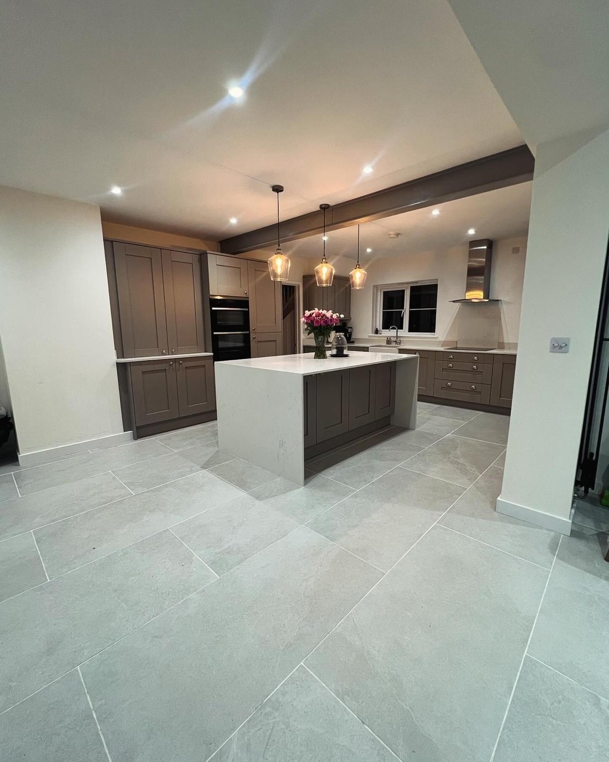 Taupe shaker kitchen with quartz island and porcelain tiled floor, Prime Build Services kitchen fitting