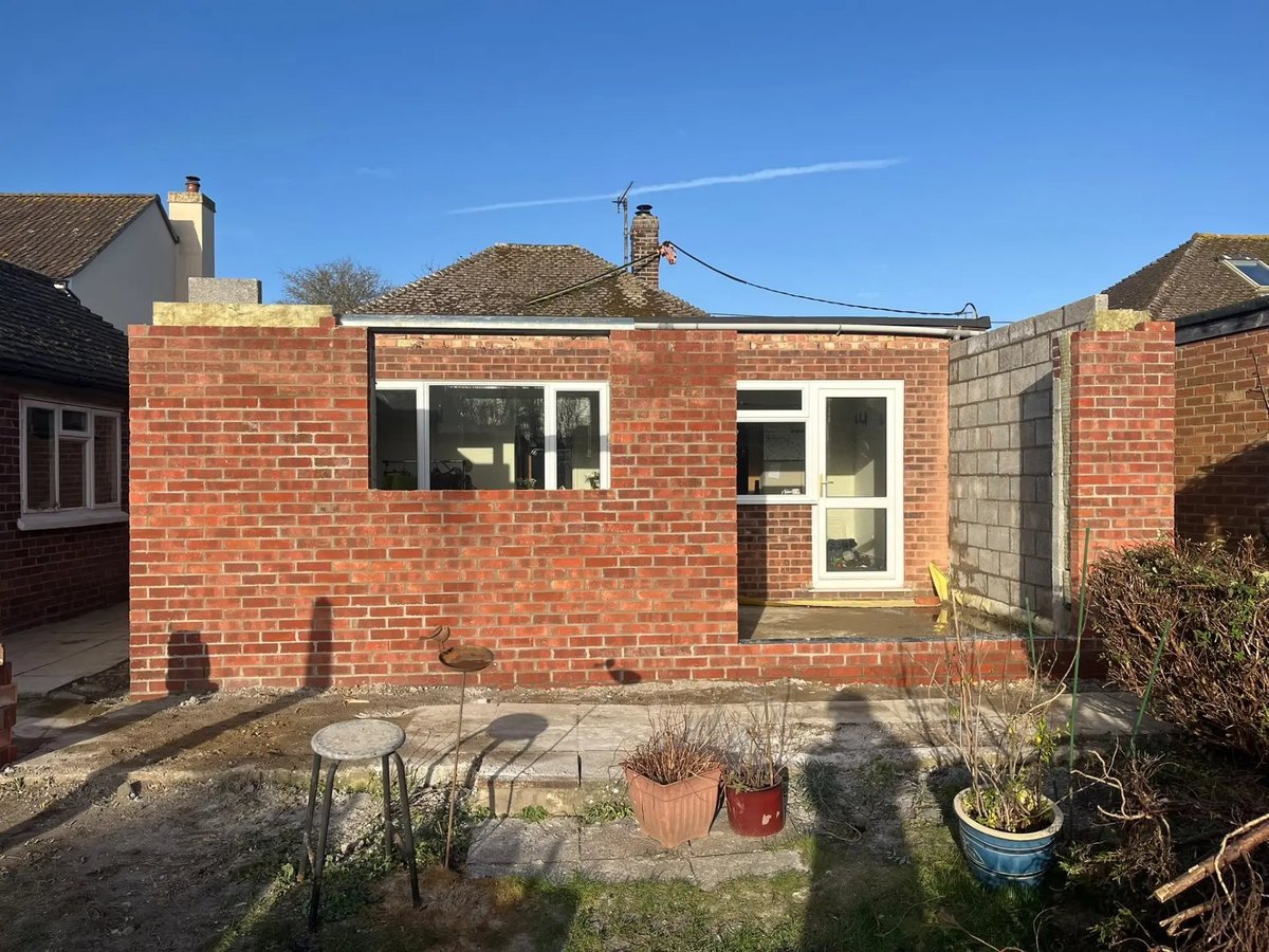 Brick extension shell with new windows and flat roof in place, Wyton