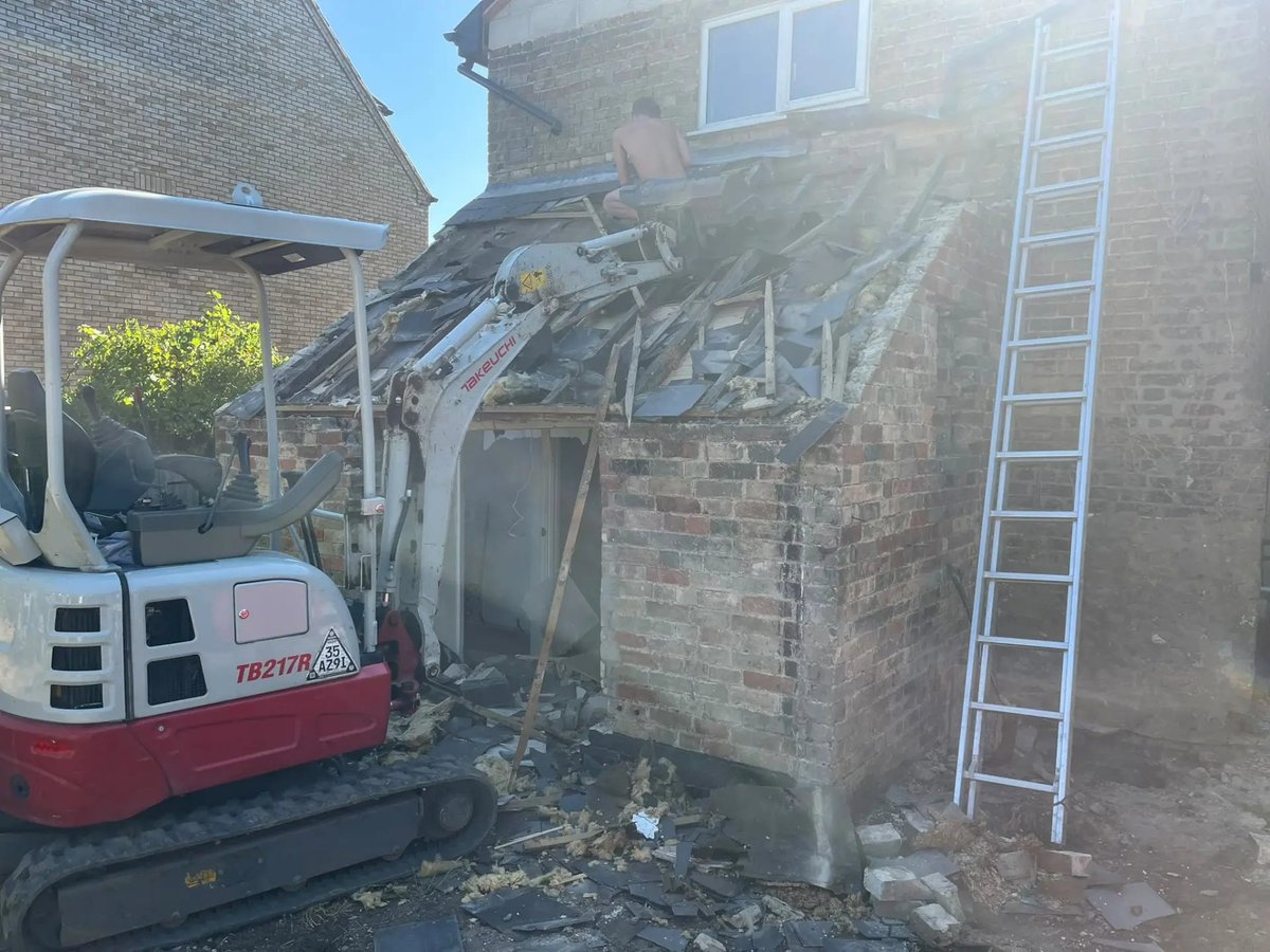 Old rear outbuilding being taken down by mini digger to clear the extension footprint, Willingham