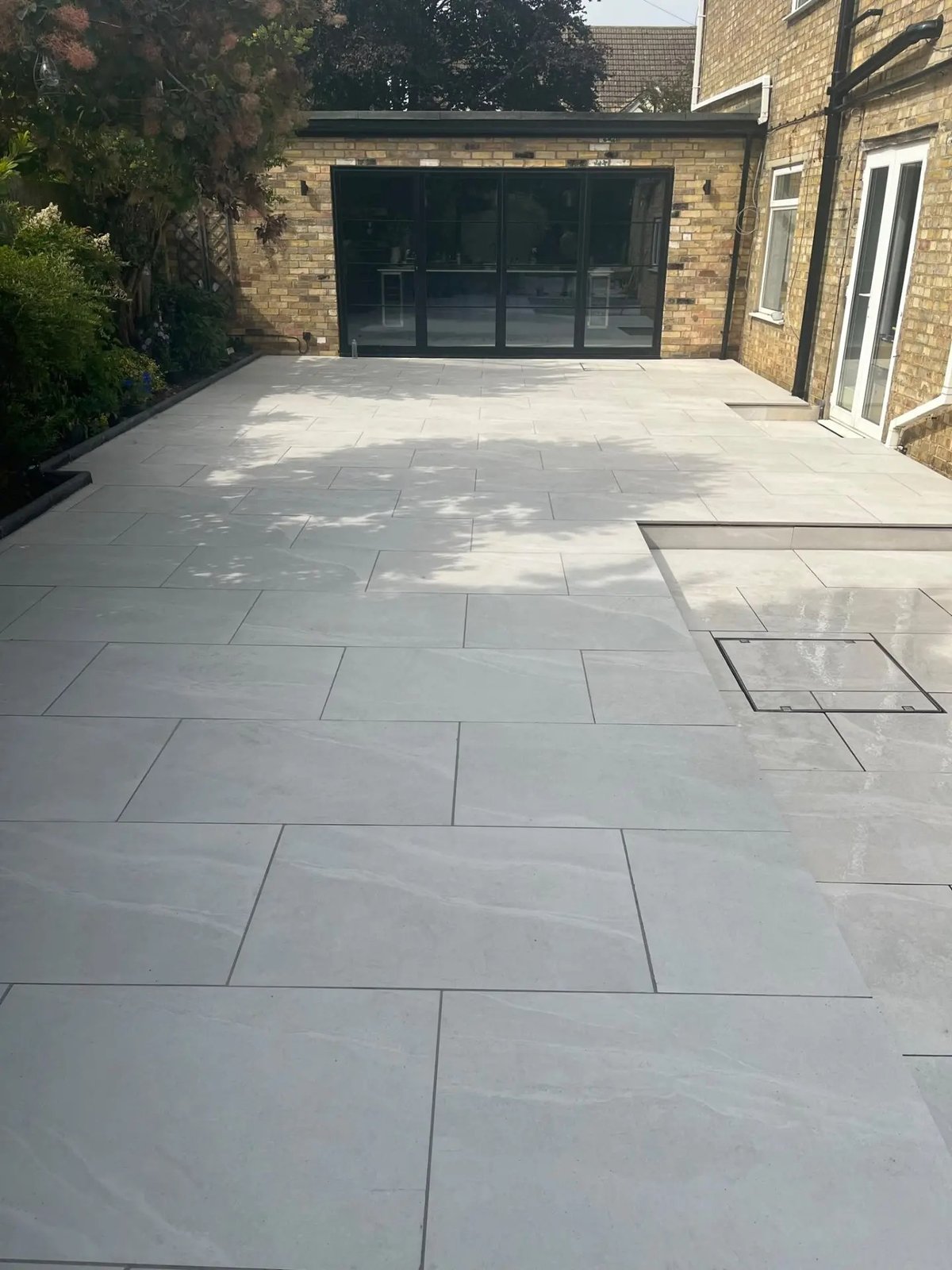 Large porcelain patio laid outside the new bifold doors, High Street Warboys