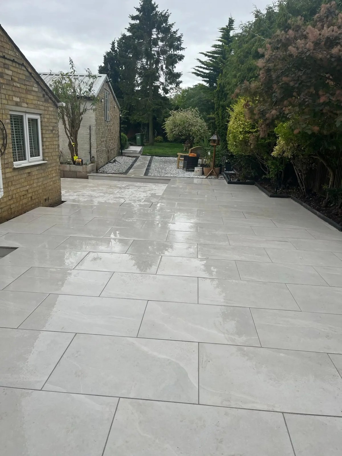 Finished porcelain patio running the width of the rear garden, High Street Warboys