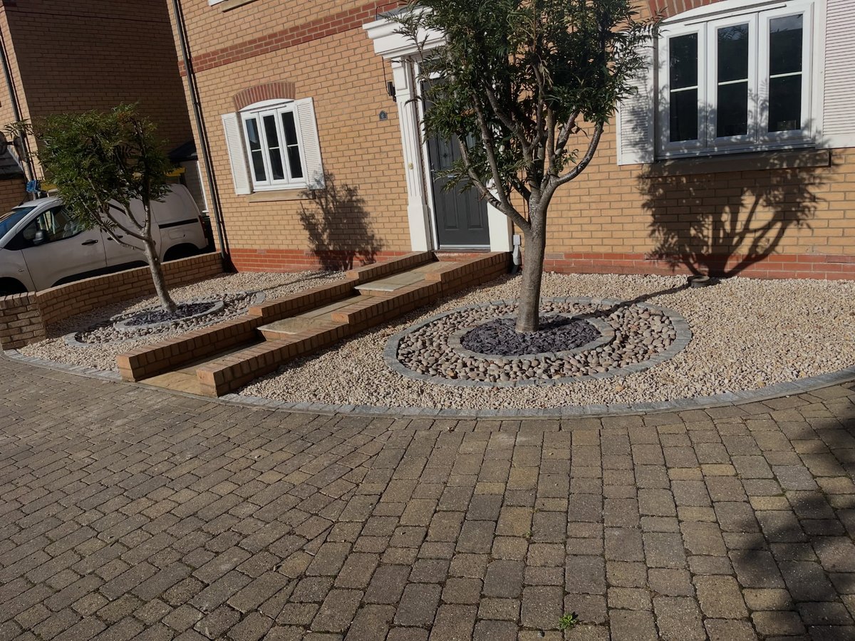 Completed front garden landscaping viewed from the driveway