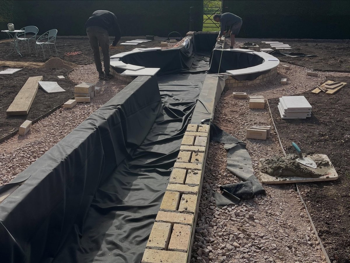 Garden water feature under construction with liner and brickwork