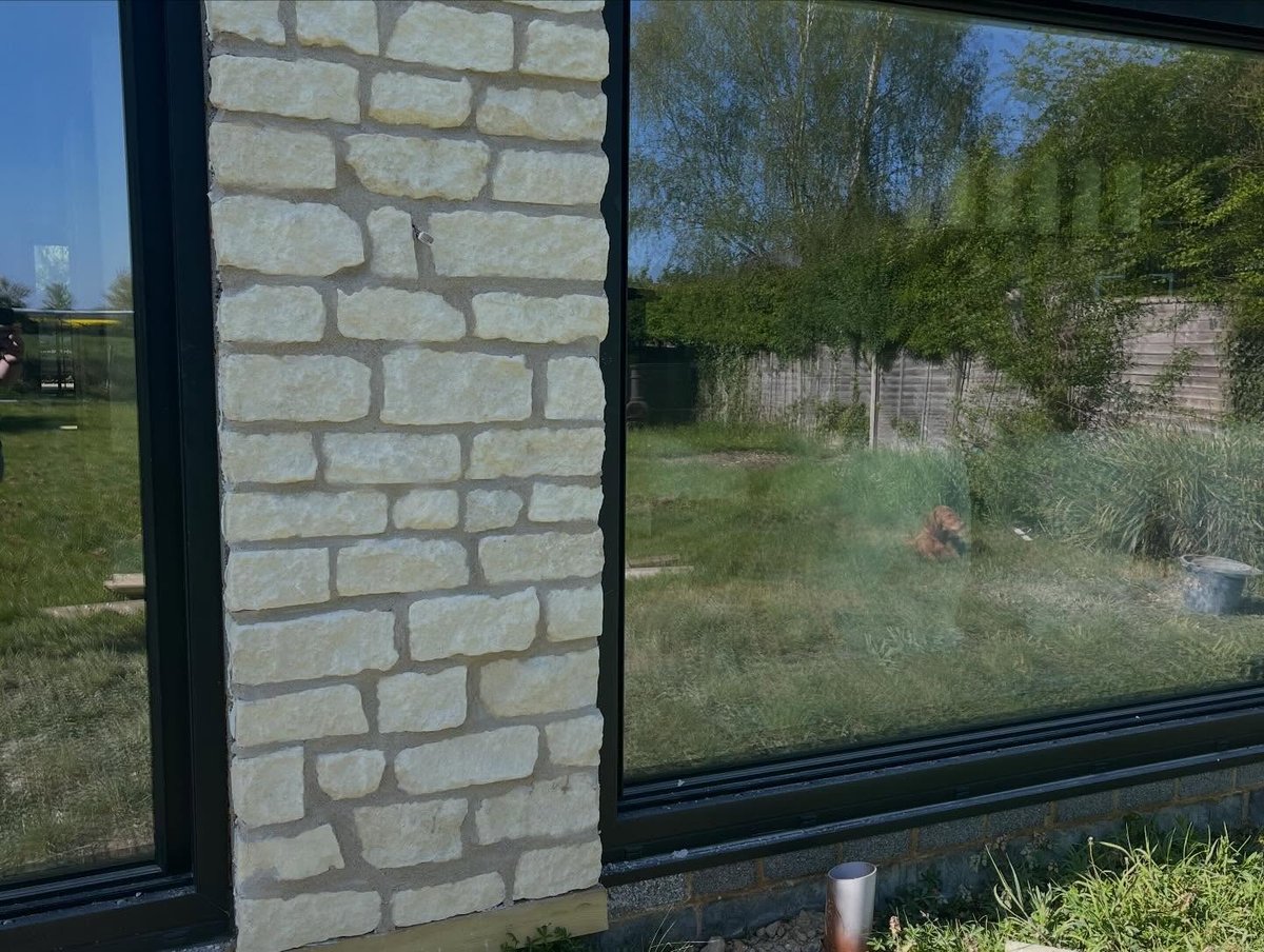 Completed natural stone cladding around windows and doors on a Cambridgeshire home