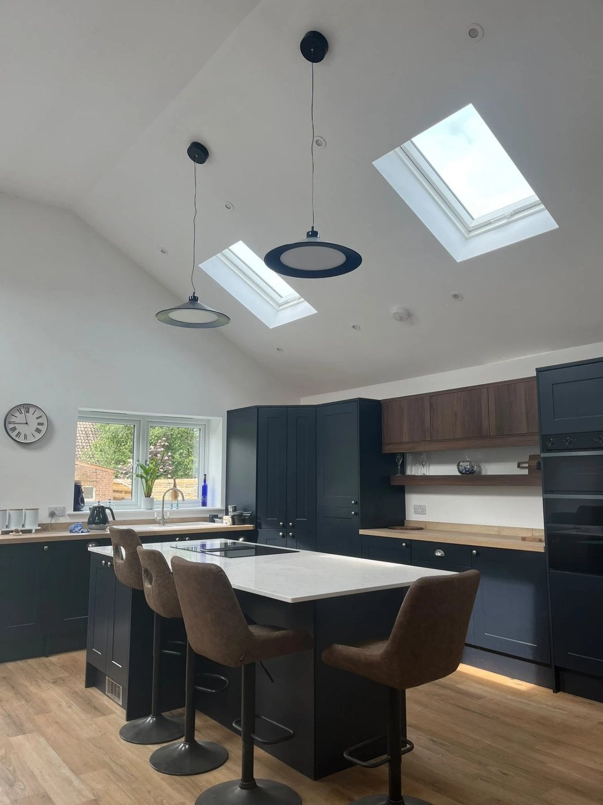 Vaulted kitchen with rooflights, pendant lights and island seating, Wyton