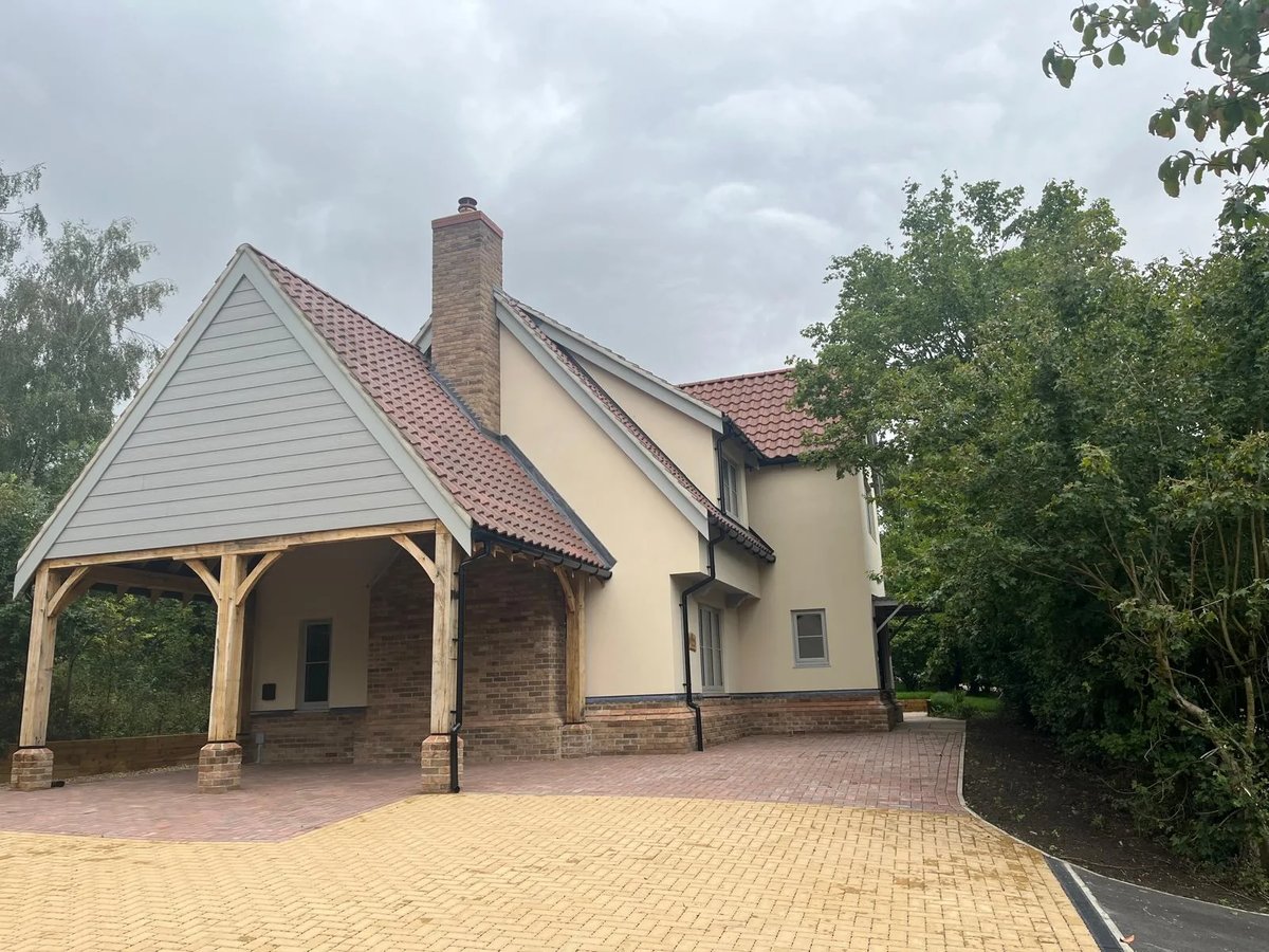 Completed new-build home with oak-framed carport, brick paving and landscaped driveway