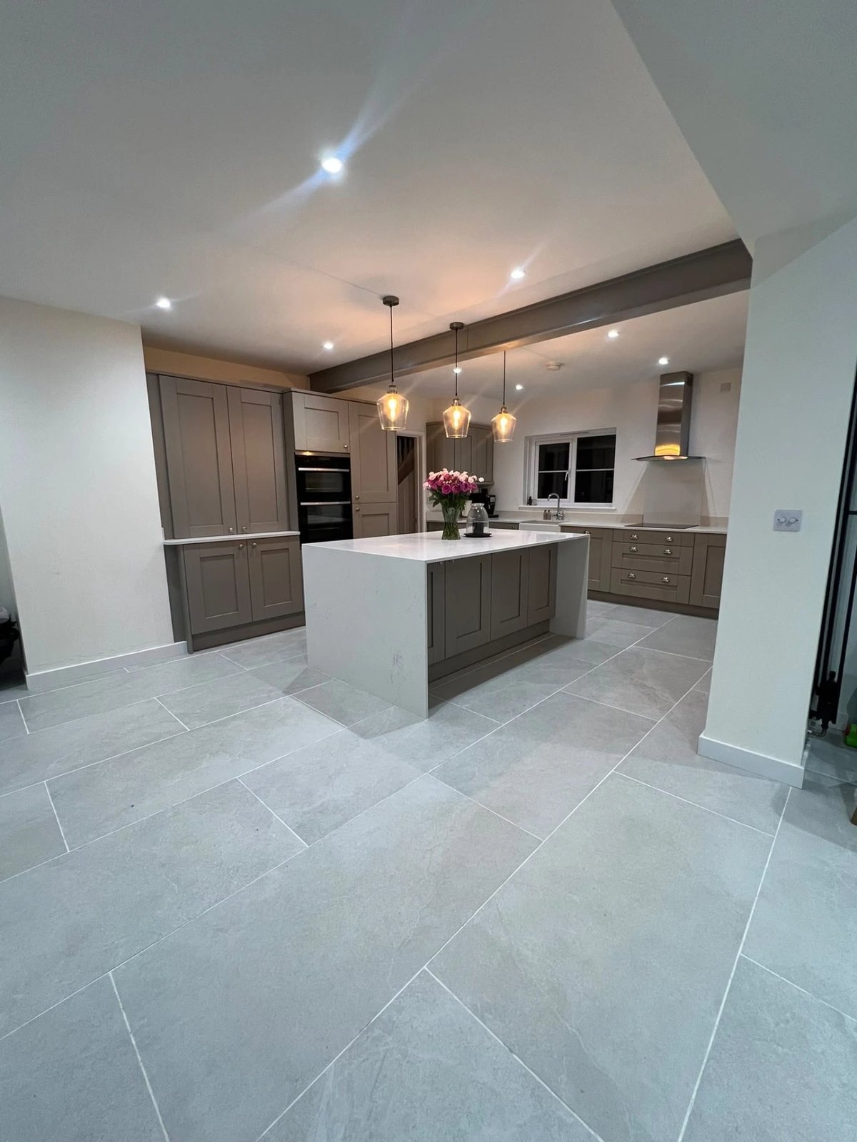 Completed open-plan kitchen with island, quartz worktops and pendant lighting, Warboys