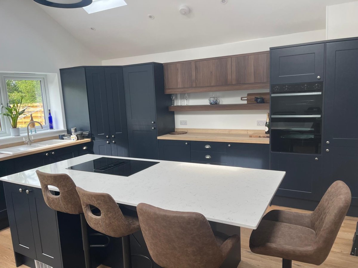 Navy and walnut kitchen with quartz island and integrated double oven, Prime Build Services kitchen fitting